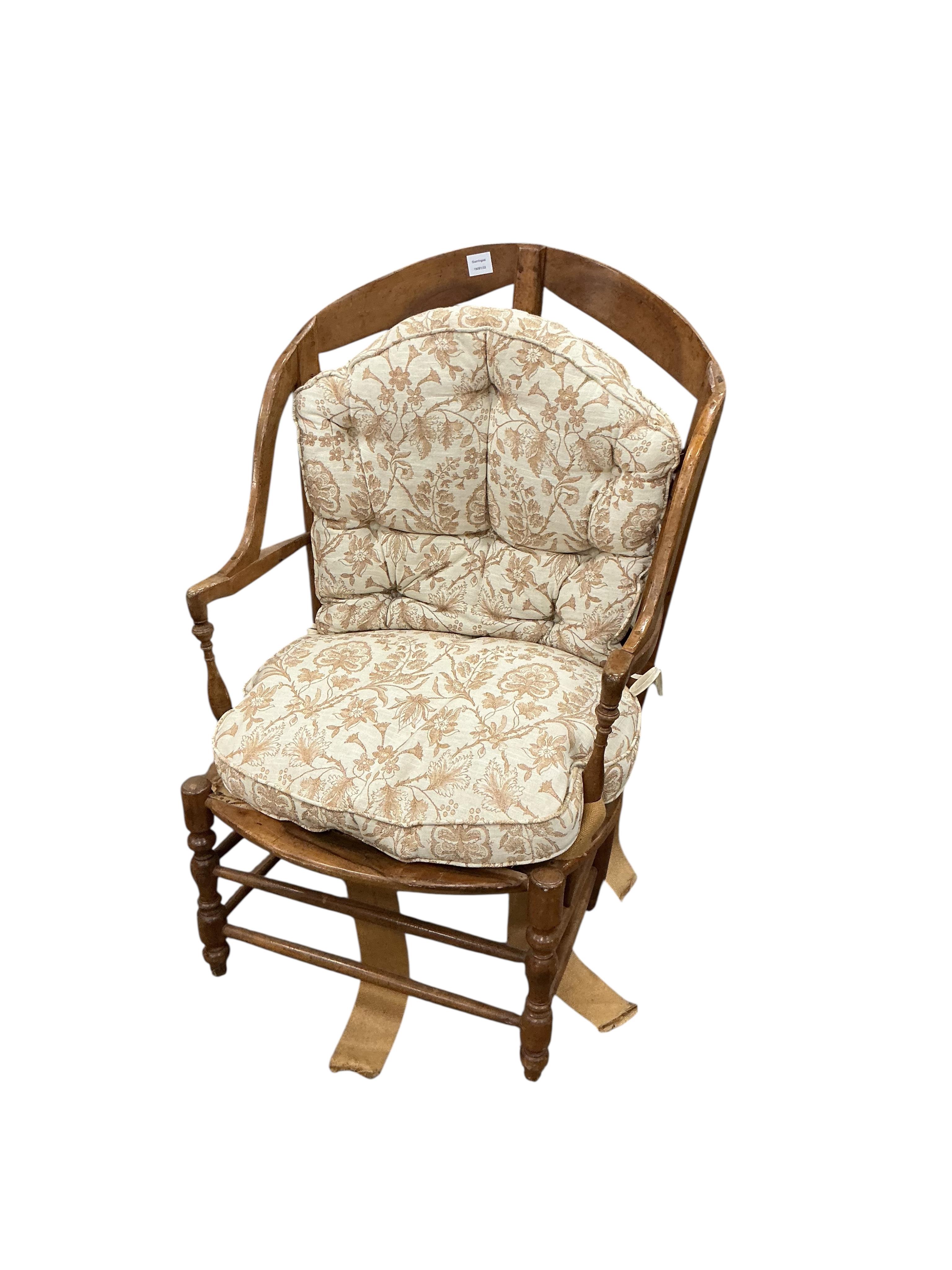 A 19th century French fruitwood armchair, width 70cm, depth 64cm, height 112cm and foot stool